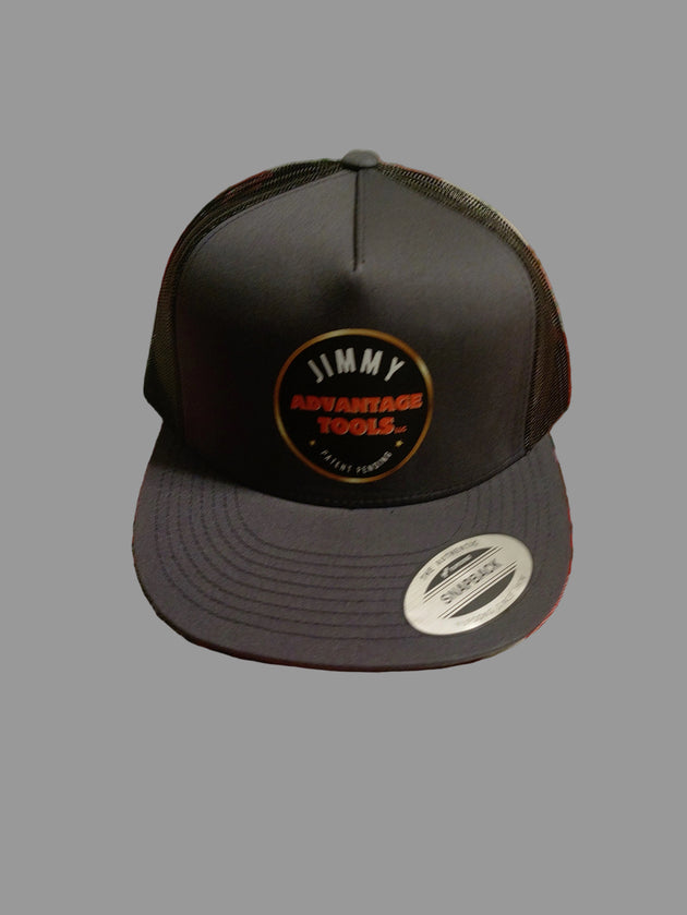 Black cap with a logo on a red and green checkered tablecloth